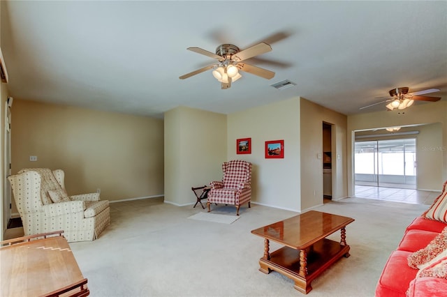 carpeted living room with ceiling fan