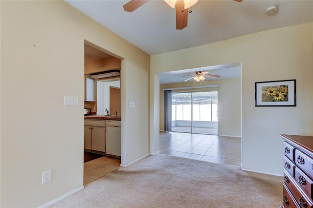 carpeted empty room featuring ceiling fan and sink