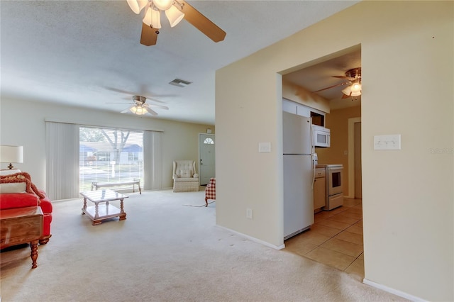 sitting room featuring light carpet