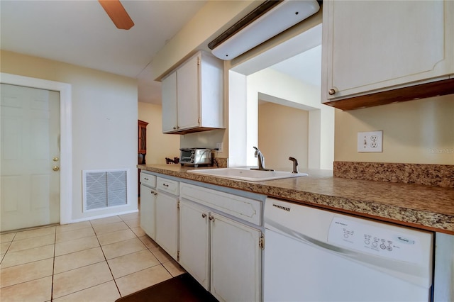 kitchen with white cabinetry, sink, white dishwasher, and light tile patterned floors