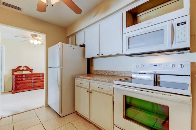 kitchen featuring white cabinets, light colored carpet, and white appliances