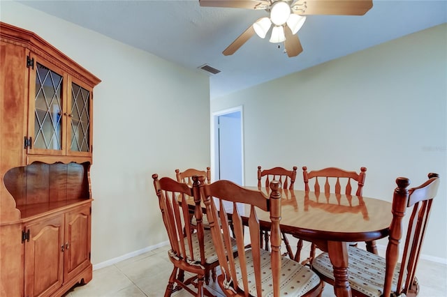 tiled dining space with ceiling fan