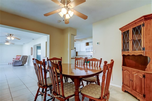 dining room with light tile patterned floors and ceiling fan