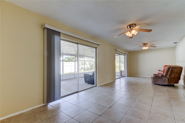 unfurnished room with light tile patterned floors and ceiling fan