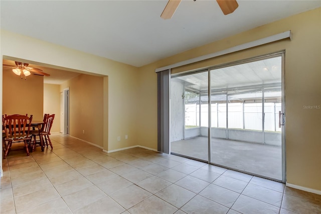 spare room with light tile patterned floors and ceiling fan