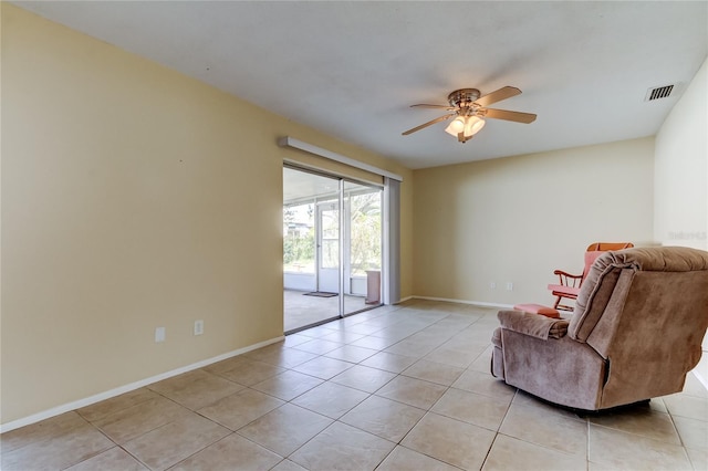 unfurnished room featuring ceiling fan and light tile patterned floors