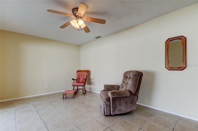 sitting room with ceiling fan and light tile patterned flooring