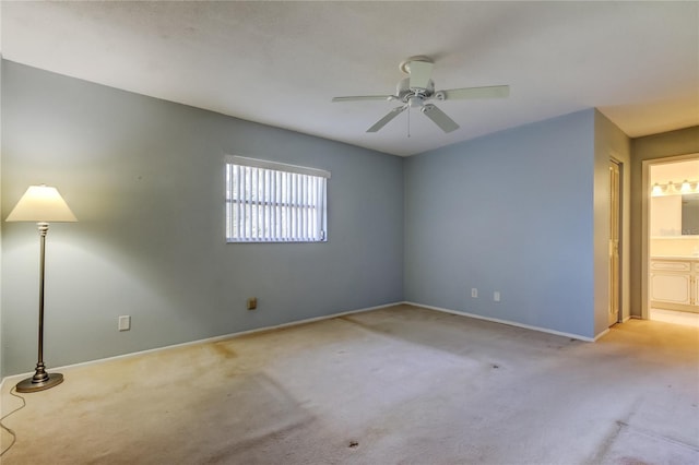 carpeted empty room featuring ceiling fan