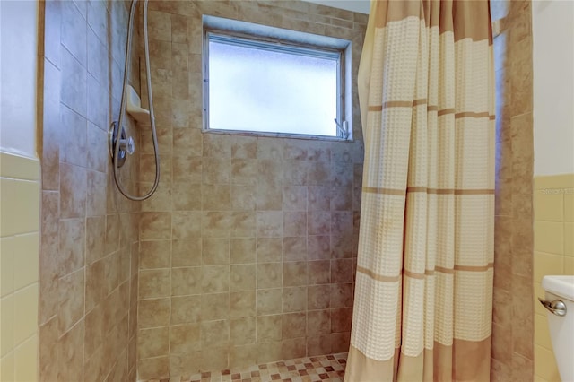 bathroom featuring curtained shower and toilet