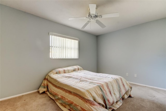 bedroom with ceiling fan and light colored carpet