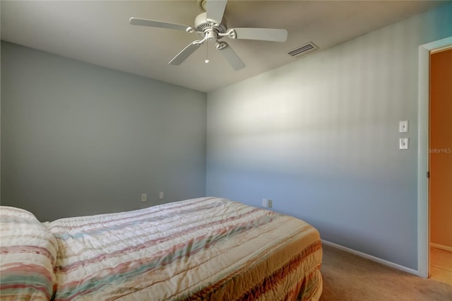 bedroom with ceiling fan and light colored carpet