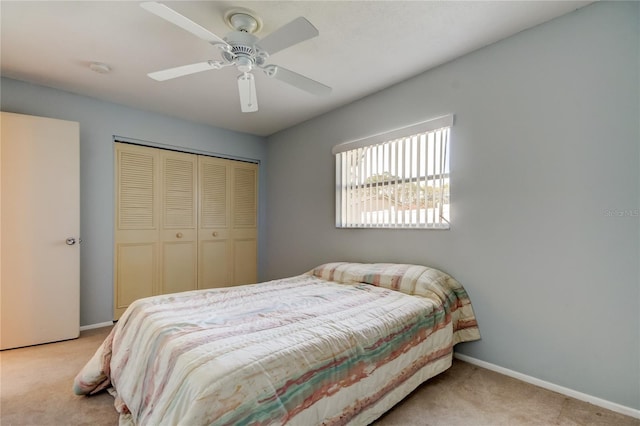 bedroom featuring light carpet, a closet, and ceiling fan