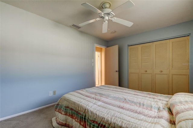 carpeted bedroom with ceiling fan and a closet