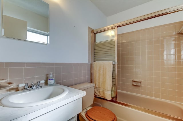 full bathroom with tasteful backsplash, vanity, tiled shower / bath combo, tile walls, and toilet