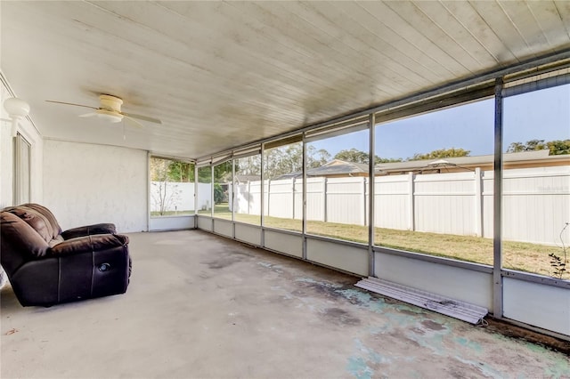 unfurnished sunroom featuring ceiling fan