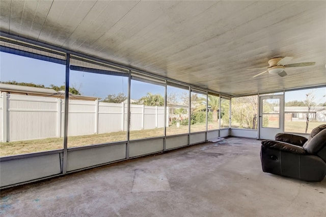 unfurnished sunroom with ceiling fan