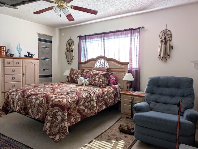 carpeted bedroom with ceiling fan and a textured ceiling