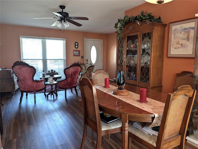 dining space with ceiling fan and dark hardwood / wood-style flooring