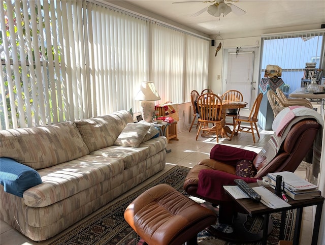 tiled living room featuring ceiling fan and plenty of natural light