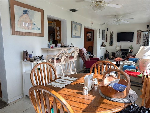 tiled dining room featuring ceiling fan