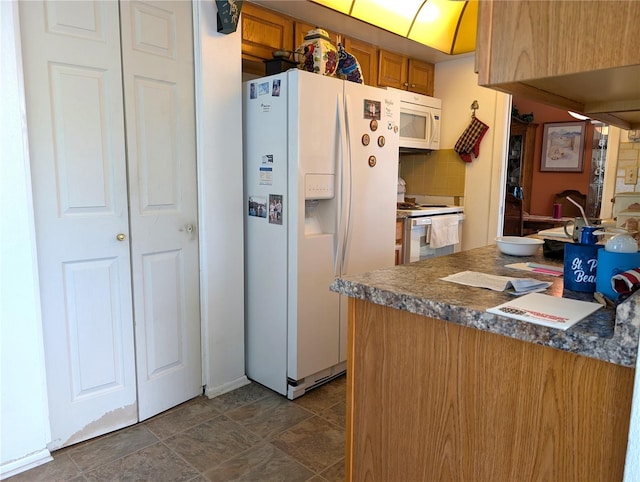 kitchen with white appliances and backsplash