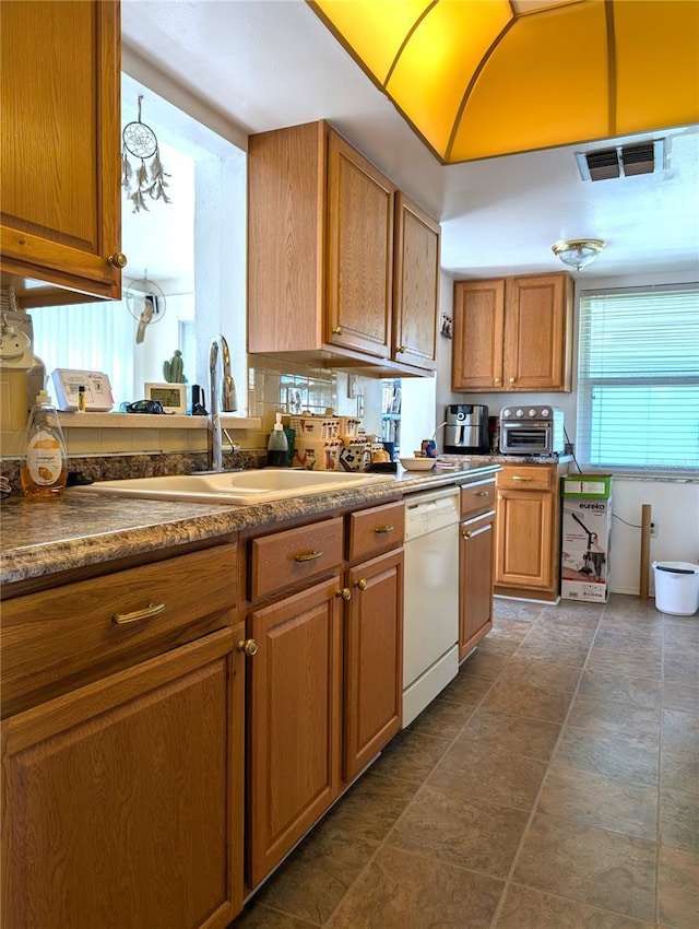 kitchen featuring white dishwasher and sink