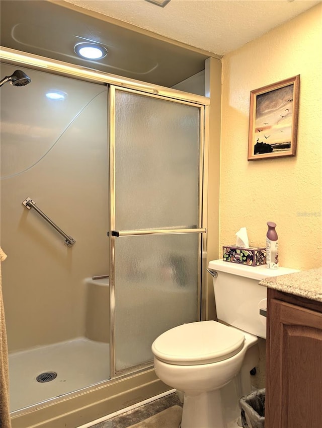 bathroom with tile patterned flooring, vanity, toilet, and an enclosed shower