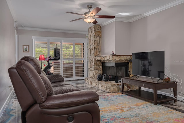 living room featuring ceiling fan, crown molding, and a fireplace