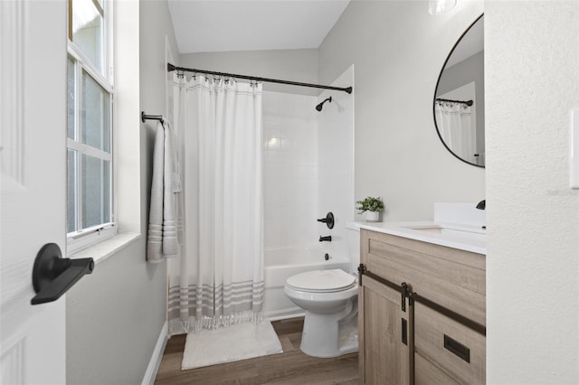 full bathroom with hardwood / wood-style floors, lofted ceiling, toilet, vanity, and shower / tub combo