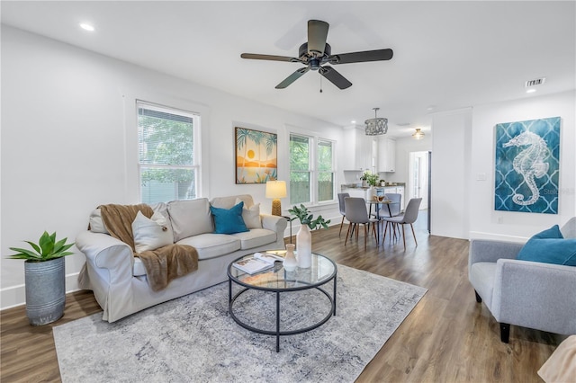 living room with hardwood / wood-style floors and ceiling fan