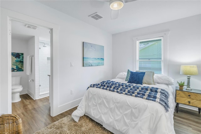 bedroom with ensuite bathroom, ceiling fan, and hardwood / wood-style flooring