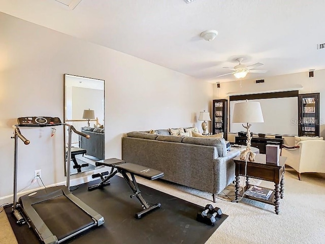 workout area with a ceiling fan and baseboards