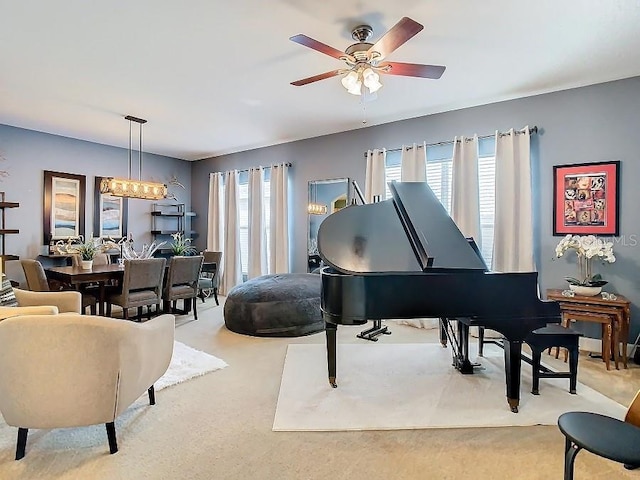 living area featuring carpet floors, plenty of natural light, and a ceiling fan