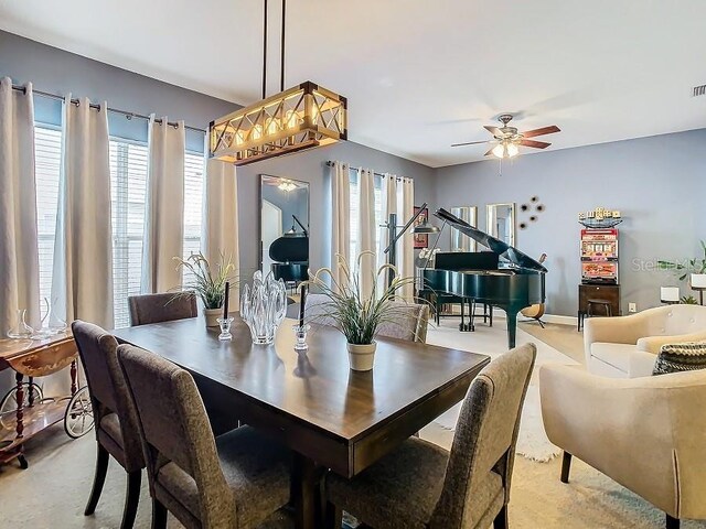 dining space featuring visible vents and a ceiling fan