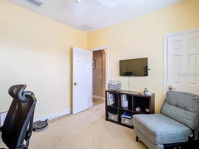 living area featuring visible vents, baseboards, arched walkways, and light colored carpet