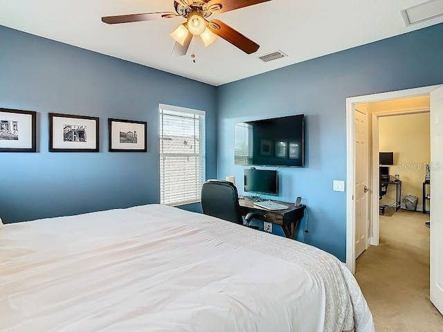 carpeted bedroom with visible vents and a ceiling fan