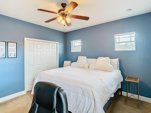 bedroom with ceiling fan, carpet floors, a closet, and baseboards