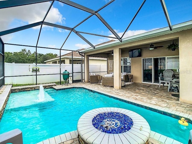 view of swimming pool with a ceiling fan, a patio area, fence, a lanai, and an outdoor living space