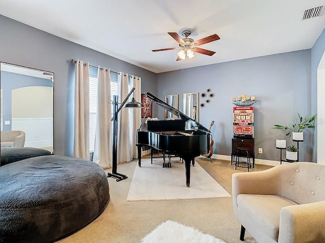 sitting room with ceiling fan, carpet, visible vents, and baseboards