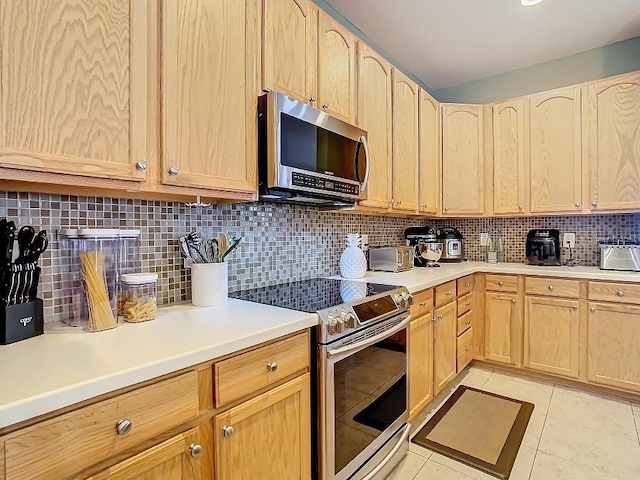 kitchen featuring stainless steel appliances, light brown cabinets, and light tile patterned floors