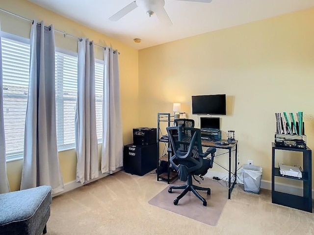 office area with light carpet, ceiling fan, and baseboards