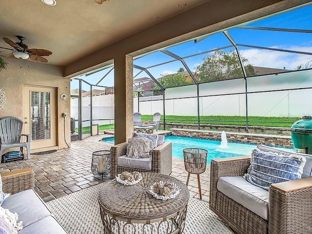 view of patio with outdoor lounge area, ceiling fan, fence, a lanai, and an outdoor pool