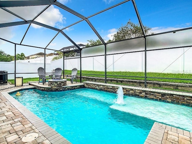 view of swimming pool with a patio, fence, and glass enclosure