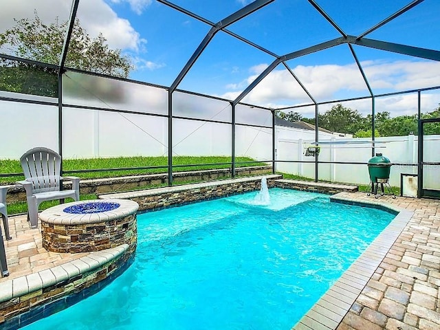 view of swimming pool with a fire pit, a patio, a lanai, and a fenced in pool