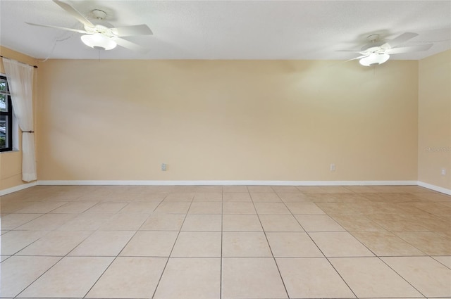 tiled spare room with ceiling fan