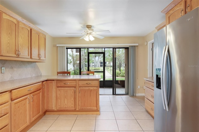 kitchen with ceiling fan, stainless steel fridge with ice dispenser, backsplash, kitchen peninsula, and light tile patterned floors