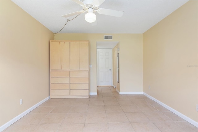 unfurnished bedroom with ceiling fan and light tile patterned floors