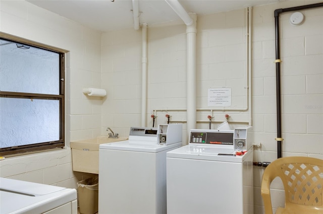 laundry area featuring separate washer and dryer and sink