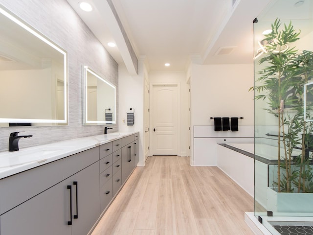 bathroom featuring decorative backsplash, walk in shower, vanity, crown molding, and wood-type flooring