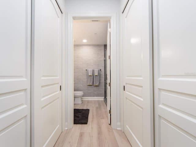 bathroom featuring wood-type flooring and toilet